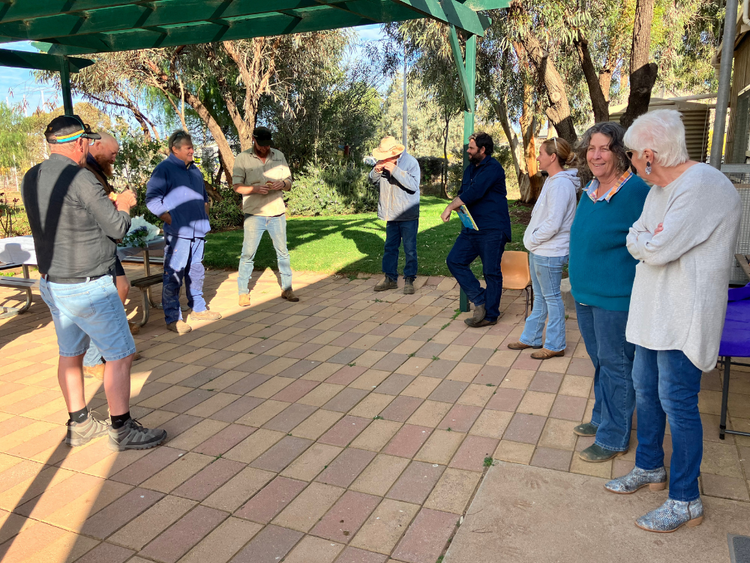 Community Members standing around talking and eating