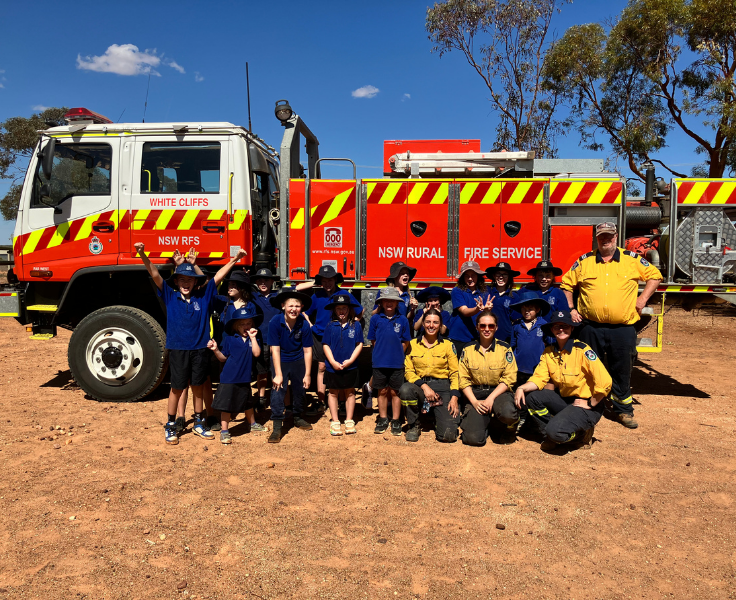 White Cliffs Students standing in front of a Fire Engine with Girls on Fire Advocates